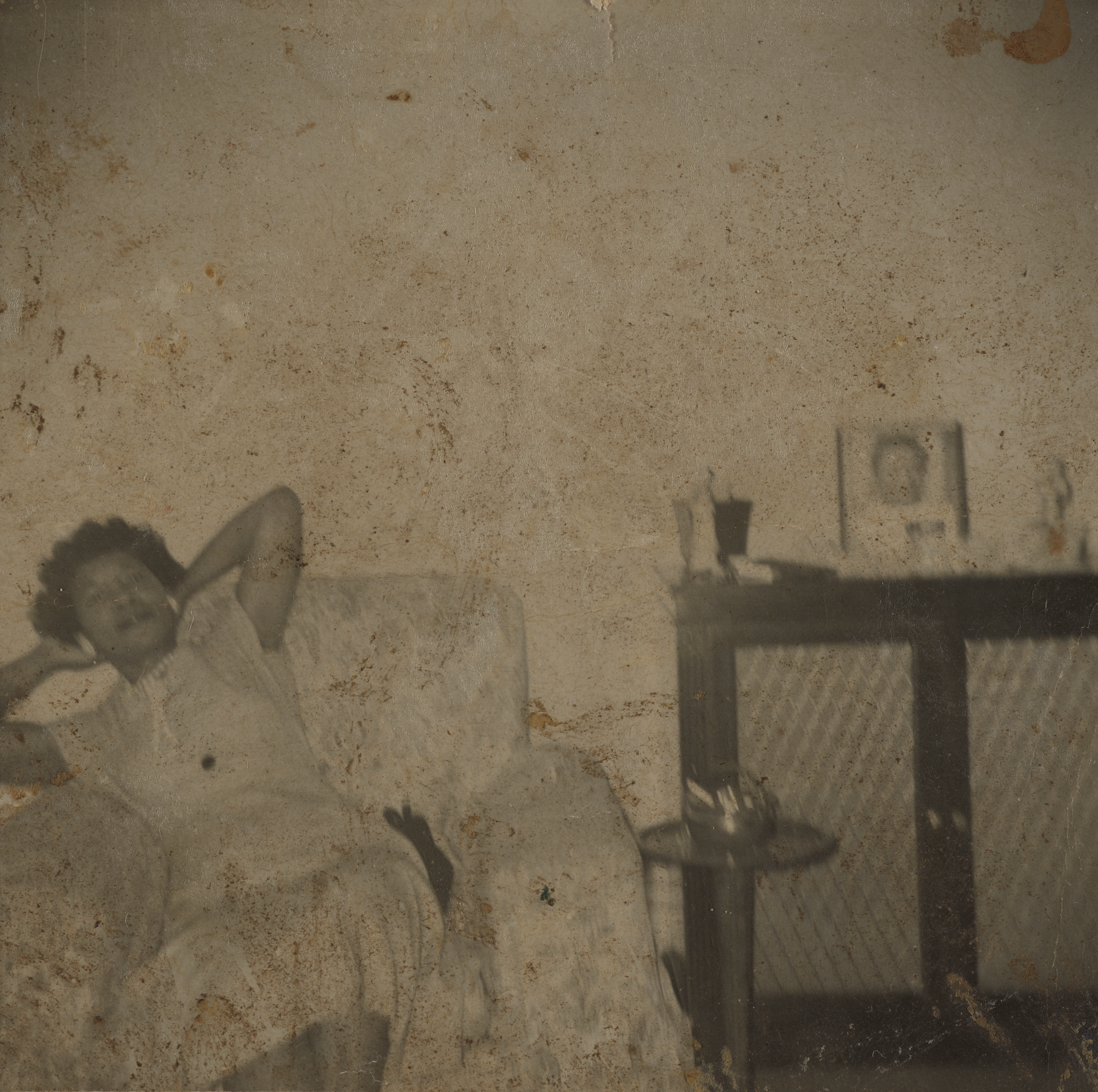 black and white snapshot of a Black woman relaxing in an easy chair