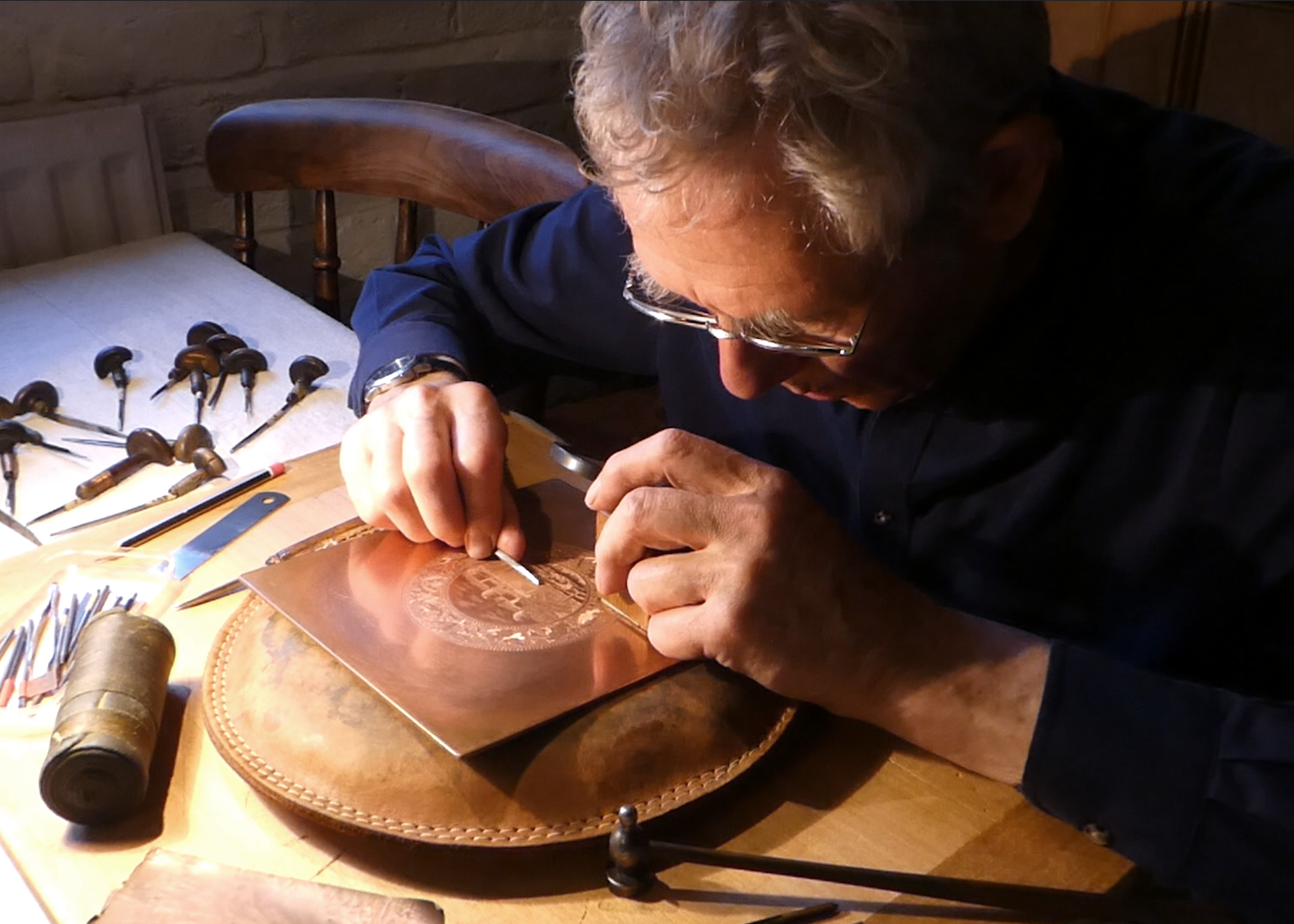 Paul Holdway engraving a copper plate