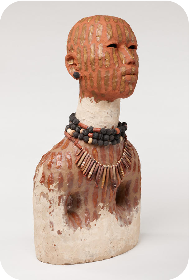 Clay bust featuring a terracotta head with golden stripes of paint, a white neck with black and brown beaded necklaces, and a terracotta striped bust with white at the base. 
