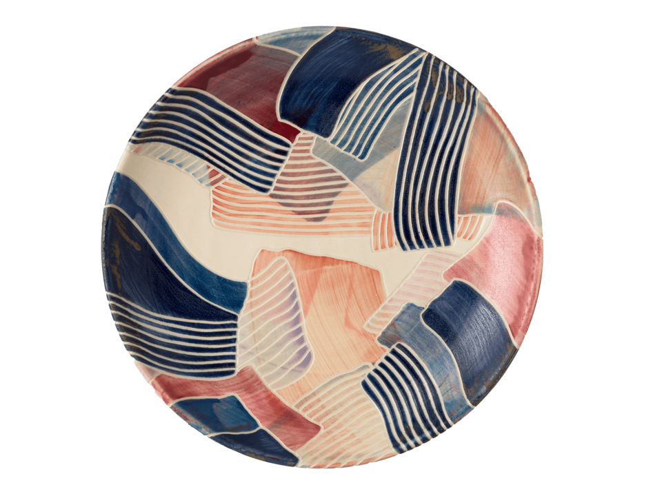 Circulate platter covered in solid and striped brushstrokes of different colors.