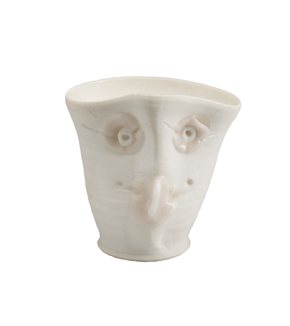 A white open vessel with a face.