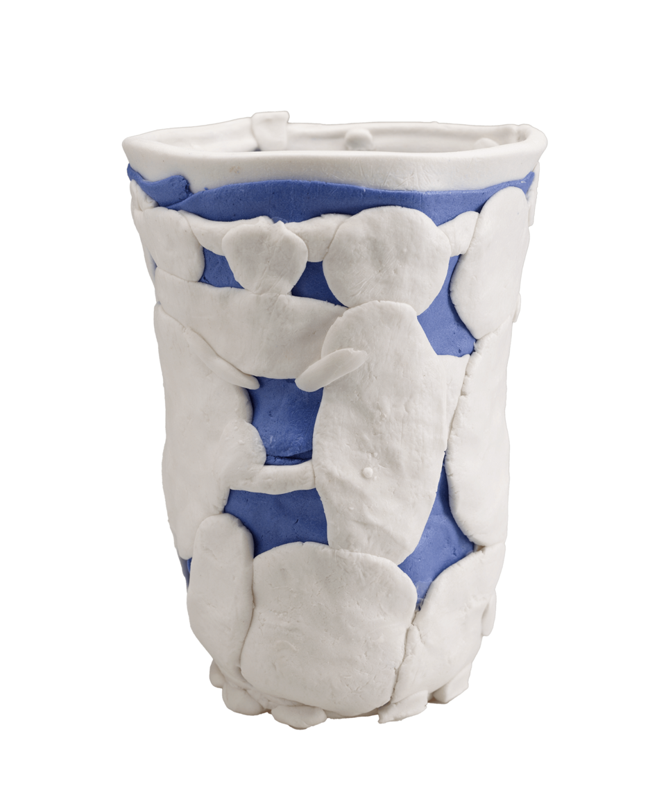 An open vessel constructed of white and blue pieces of clay in various shapes, layered on top of one another. 