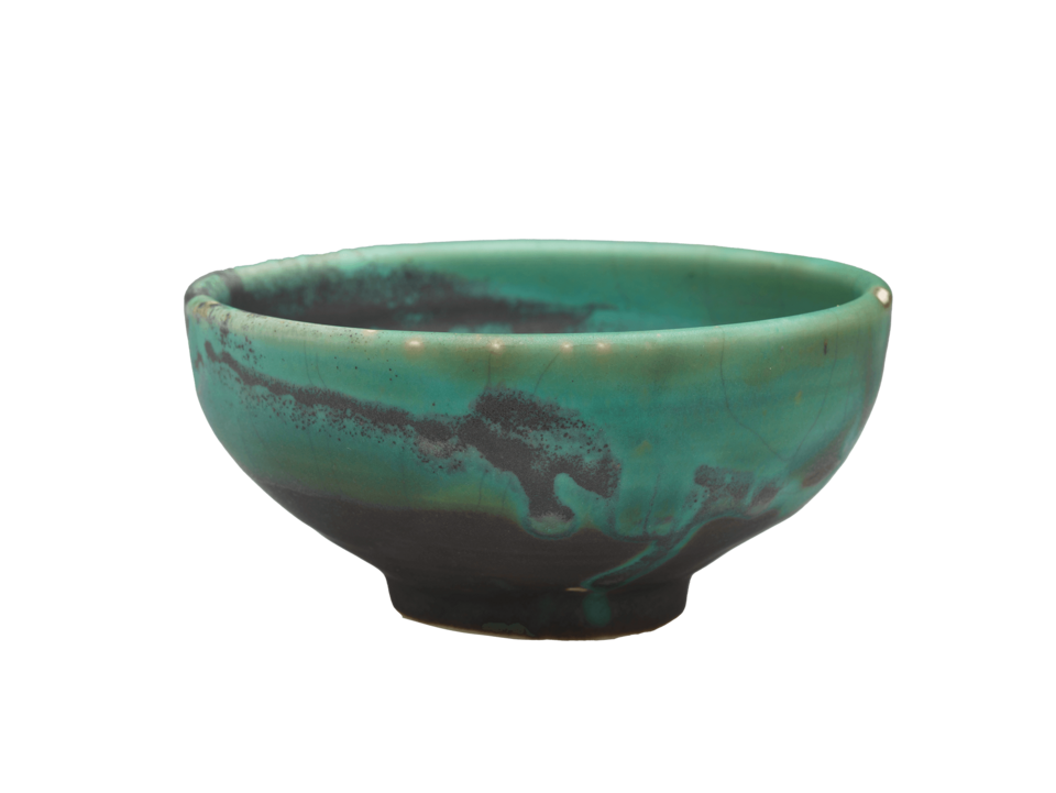 Green bowl with splashes of dark gray on side and at base.