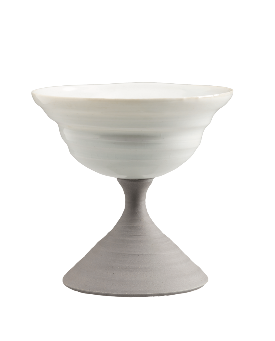 A compote in an hourglass shape. A white bowl rests on top of a gray base.