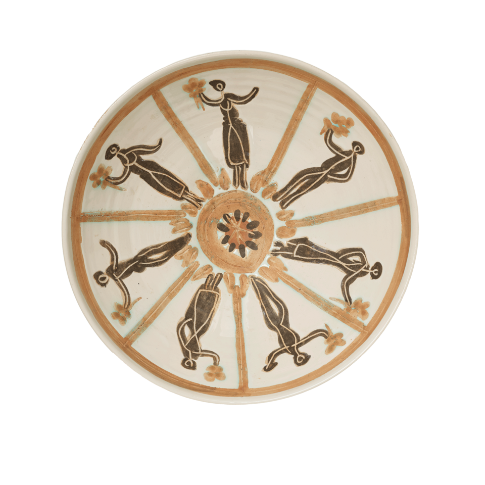 Interior of the same bowl. Dark brown figures with scratched outlines holding flowers, separated by orange lines, arranged in a circular pattern around an orange circle in the center. 