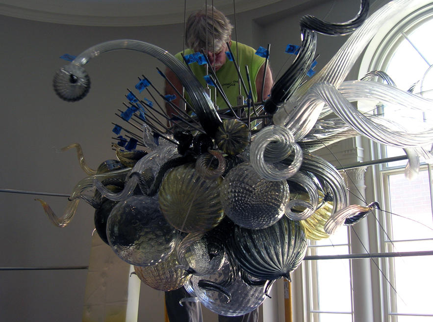 Art handler reassembling Dale Chihuly, Gilded Frost and Jet Chandelier
