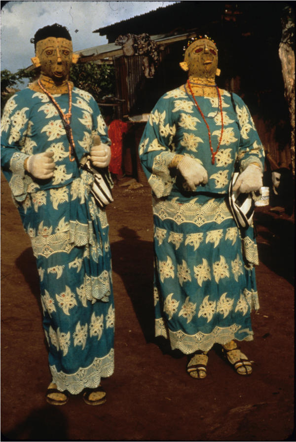 A pair of masqueraders honors the spirits of departed twins, 1986.